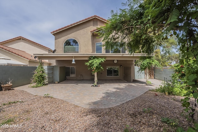 533 N Cobblestone St, Gilbert, AZ 85234 - back of property featuring stucco siding, a fenced backyard, a patio, and a tile roof