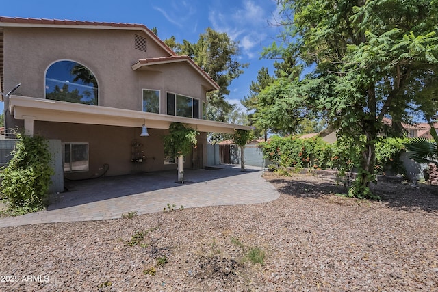 533 N Cobblestone St, Gilbert, AZ 85234 - back of house featuring stucco siding and a patio