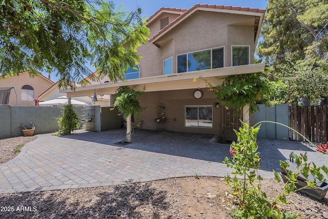 533 N Cobblestone St, Gilbert, AZ 85234 - back of house featuring stucco siding, a tiled roof, and a patio