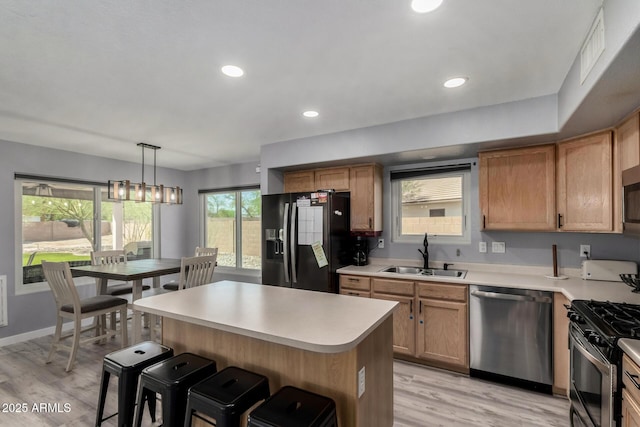 2934 S Woodruff Cir, Mesa, AZ 85212 - kitchen with appliances with stainless steel finishes, a breakfast bar, light wood-style flooring, light countertops, and recessed lighting