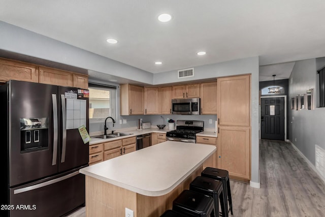 2934 S Woodruff Cir, Mesa, AZ 85212 - kitchen with appliances with stainless steel finishes, light wood-style floors, light countertops, a center island, and recessed lighting