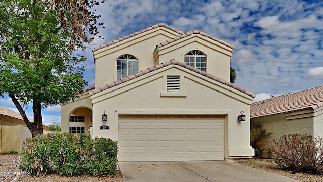 mediterranean / spanish-style house featuring a garage