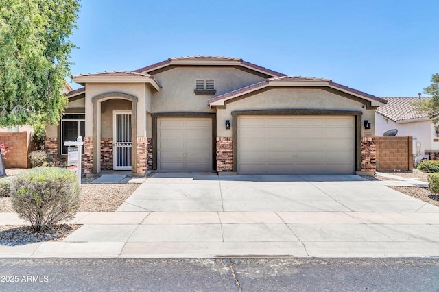 17429 W Red Bird Rd, Surprise, AZ 85387 - view of front of house featuring a tiled roof, an attached garage, concrete driveway, and stucco siding