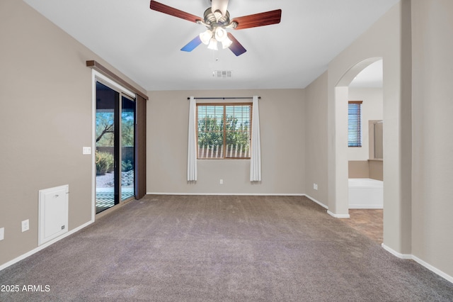 17429 W Red Bird Rd, Surprise, AZ 85387 - carpeted empty room with arched walkways, ceiling fan, visible vents, and baseboards