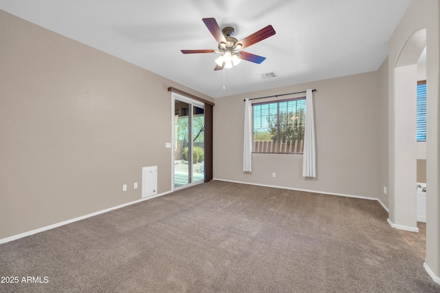 17429 W Red Bird Rd, Surprise, AZ 85387 - carpeted empty room with arched walkways, ceiling fan, visible vents, and baseboards