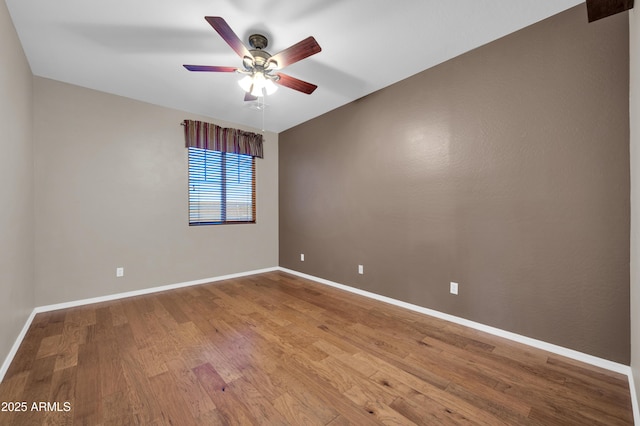 17429 W Red Bird Rd, Surprise, AZ 85387 - unfurnished room featuring baseboards, a ceiling fan, and wood finished floors