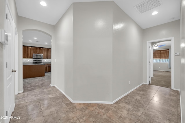 17429 W Red Bird Rd, Surprise, AZ 85387 - hall with visible vents, arched walkways, light tile patterned floors, baseboards, and recessed lighting