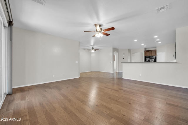 17429 W Red Bird Rd, Surprise, AZ 85387 - unfurnished living room with a ceiling fan, visible vents, baseboards, wood-type flooring, and recessed lighting
