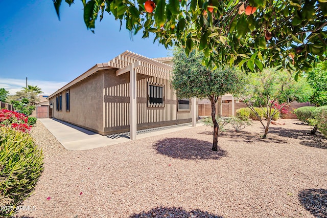 17429 W Red Bird Rd, Surprise, AZ 85387 - back of house featuring a fenced backyard, a patio area, stucco siding, and a pergola