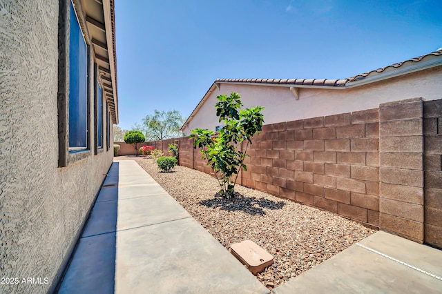 17429 W Red Bird Rd, Surprise, AZ 85387 - view of side of property with a fenced backyard, a patio, and stucco siding
