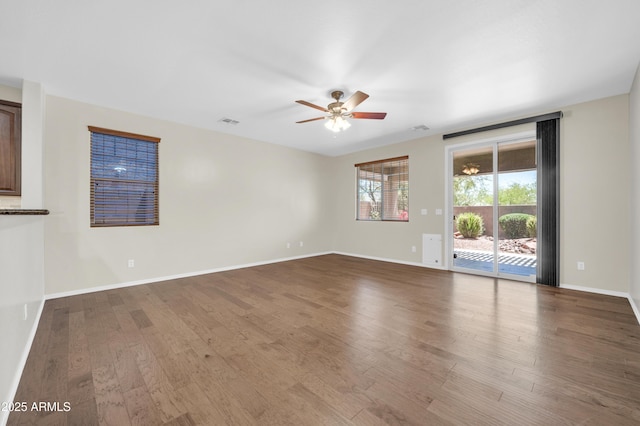 17429 W Red Bird Rd, Surprise, AZ 85387 - spare room featuring baseboards, ceiling fan, wood finished floors, and visible vents