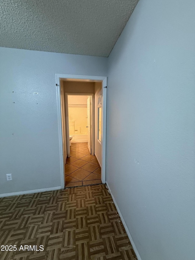 4231 N 69th Dr Unit 1297, Phoenix, AZ 85033 - hall with baseboards and a textured ceiling