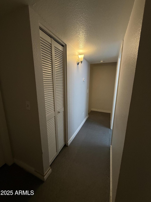 4231 N 69th Dr Unit 1297, Phoenix, AZ 85033 - hallway featuring carpet floors, a textured ceiling, and baseboards