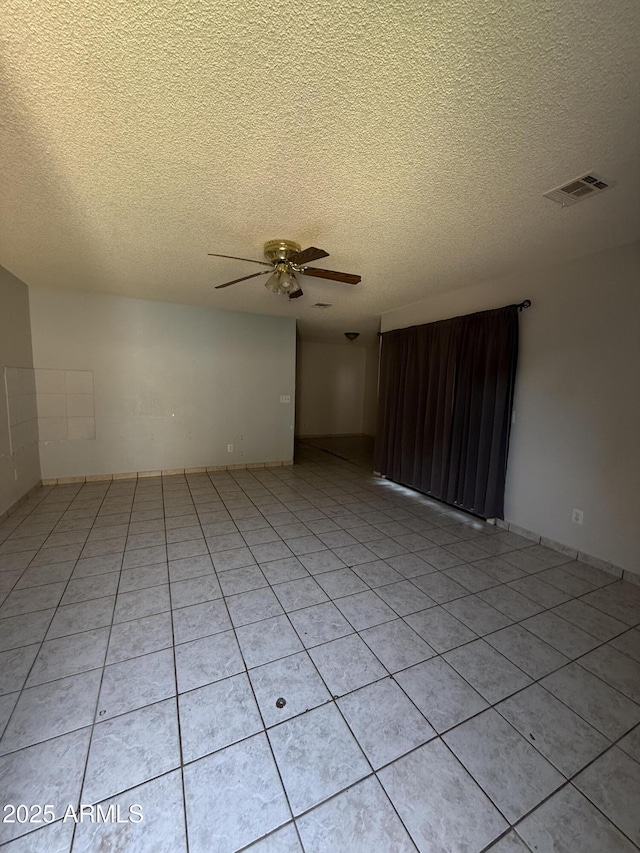 4231 N 69th Dr Unit 1297, Phoenix, AZ 85033 - spare room with a ceiling fan, a textured ceiling, and light tile patterned flooring