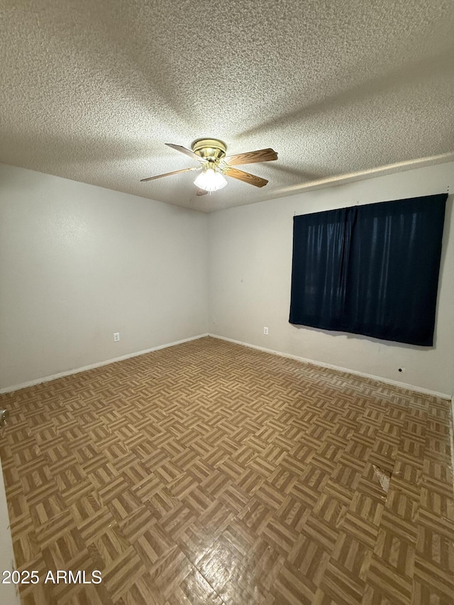 4231 N 69th Dr Unit 1297, Phoenix, AZ 85033 - spare room with a ceiling fan, a textured ceiling, and baseboards