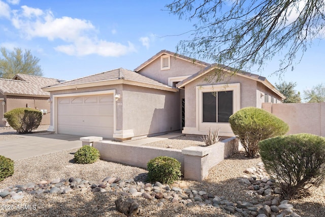 view of front facade with concrete driveway, an attached garage, and stucco siding