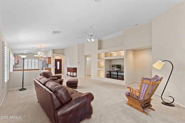 living room featuring baseboards, built in features, visible vents, light colored carpet, and ceiling fan with notable chandelier
