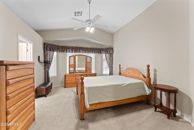 bedroom with baseboards, visible vents, a ceiling fan, light colored carpet, and vaulted ceiling