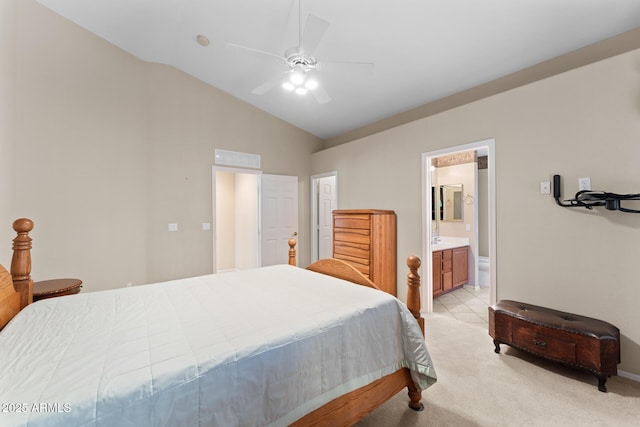 bedroom featuring vaulted ceiling, ceiling fan, connected bathroom, and light colored carpet