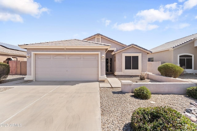 single story home with driveway, fence, an attached garage, and stucco siding