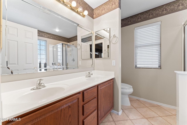 bathroom featuring tile patterned flooring, a sink, a shower stall, and double vanity