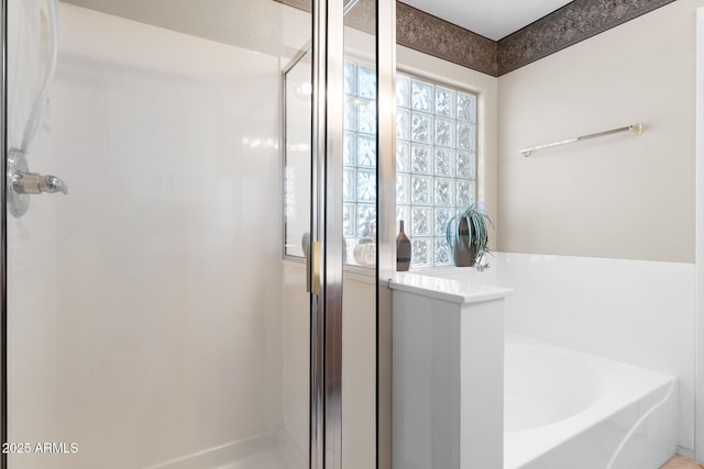 full bath with a shower stall and a bath