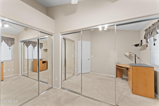 unfurnished bedroom featuring baseboards and light colored carpet