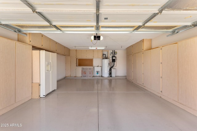 garage featuring water heater, white refrigerator with ice dispenser, a sink, and a garage door opener