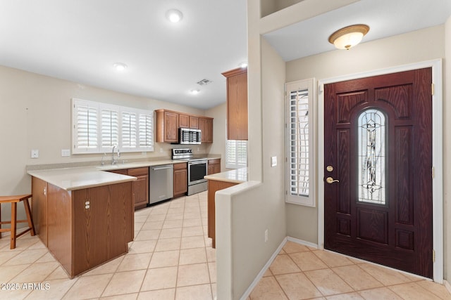 foyer entrance with visible vents, baseboards, and light tile patterned floors