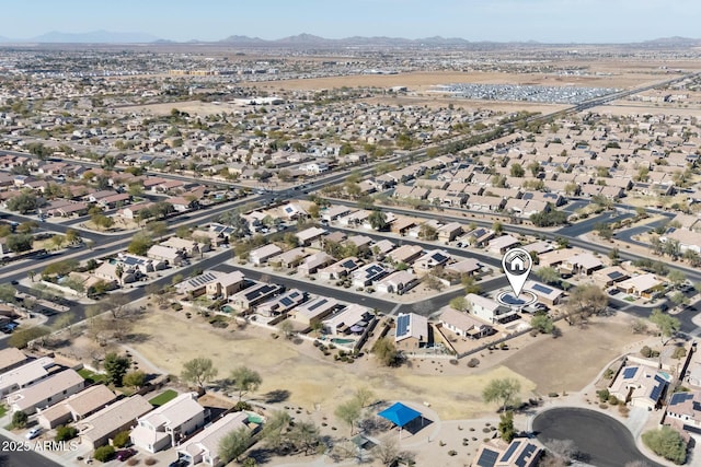 birds eye view of property featuring a residential view, a mountain view, and view of desert