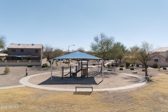 view of home's community with playground community and fence