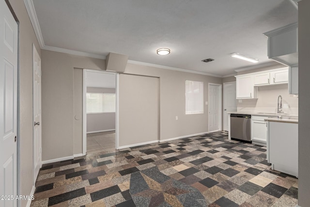 kitchen featuring stainless steel dishwasher, light countertops, crown molding, and a sink