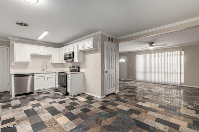 kitchen with a sink, visible vents, appliances with stainless steel finishes, and ornamental molding