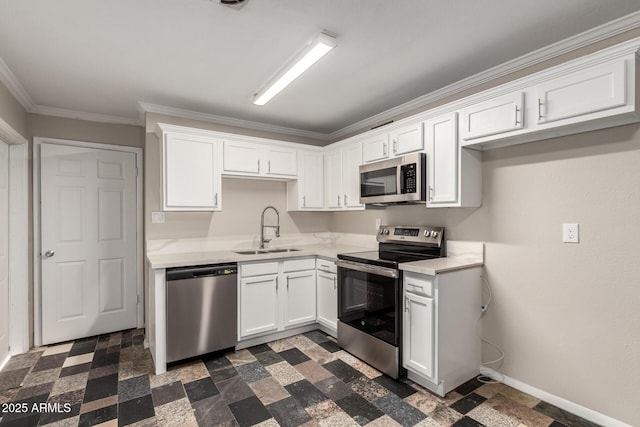 kitchen with a sink, appliances with stainless steel finishes, white cabinets, light countertops, and baseboards