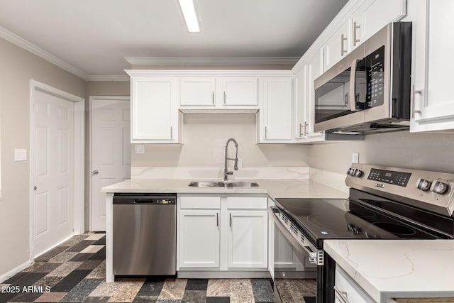 kitchen with crown molding, white cabinets, appliances with stainless steel finishes, and a sink