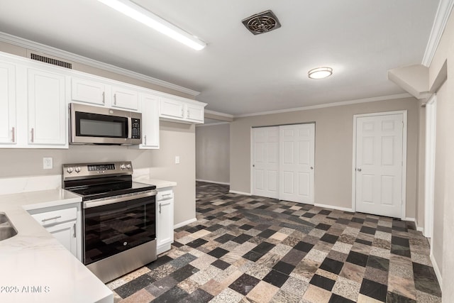 kitchen featuring stainless steel appliances, white cabinetry, crown molding, and light countertops