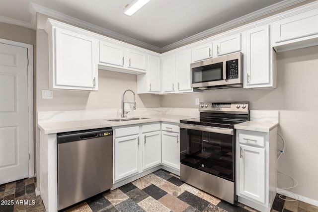 kitchen with light stone counters, baseboards, a sink, appliances with stainless steel finishes, and white cabinetry