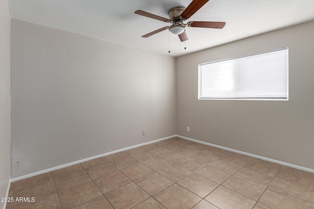 empty room featuring baseboards and a ceiling fan