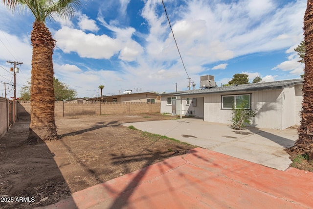 rear view of house featuring a patio area and a fenced backyard