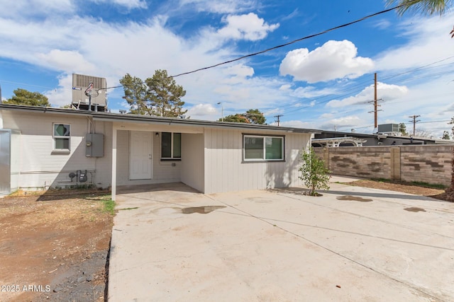 rear view of property with a patio, central AC, and fence