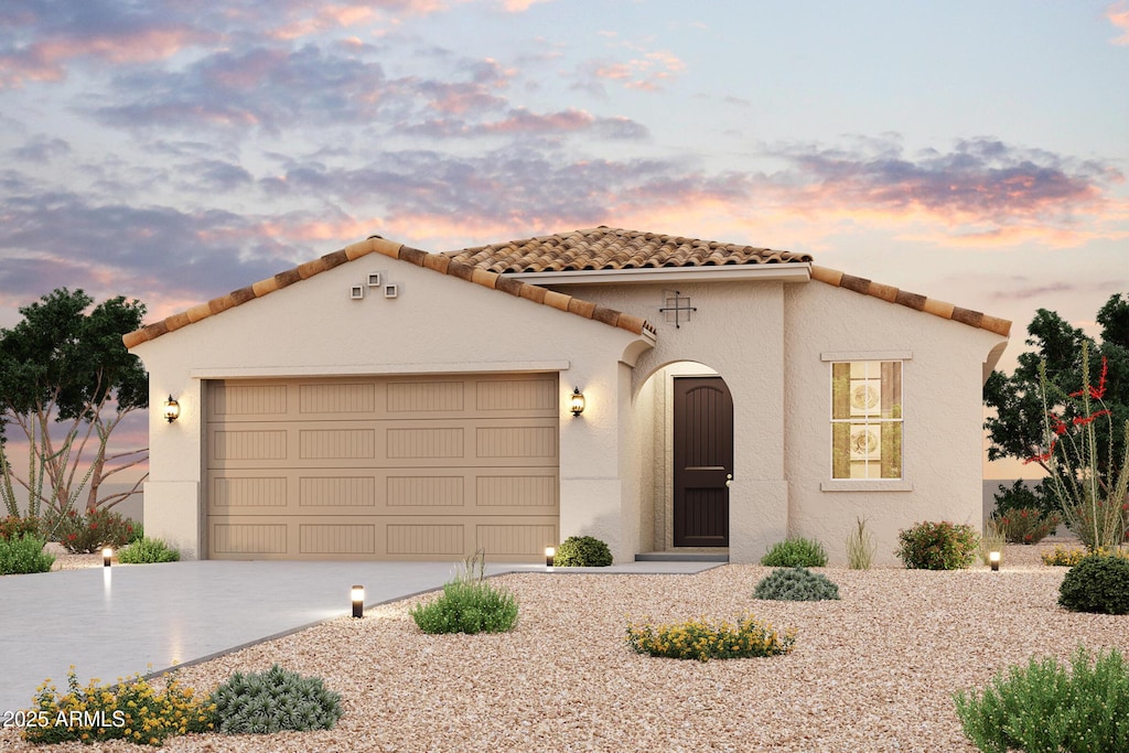 17753 W Fulton St, Goodyear, AZ 85338 - mediterranean / spanish home with an attached garage, concrete driveway, a tiled roof, and stucco siding
