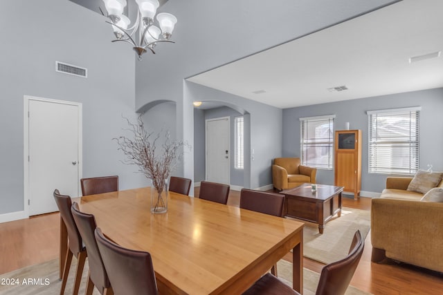 dining area with a notable chandelier and light wood-type flooring