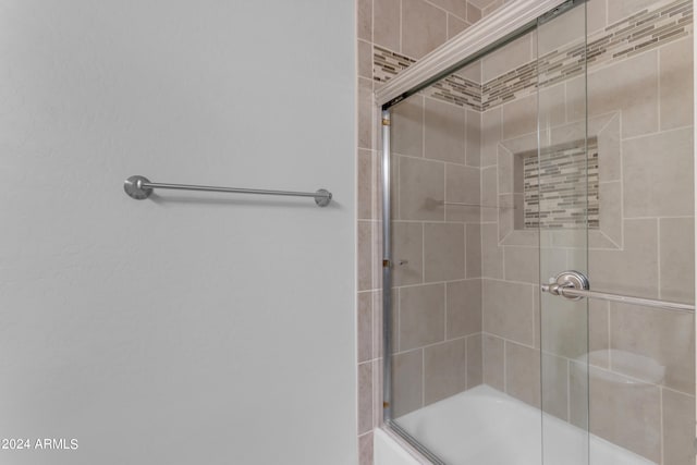 bathroom featuring bath / shower combo with glass door