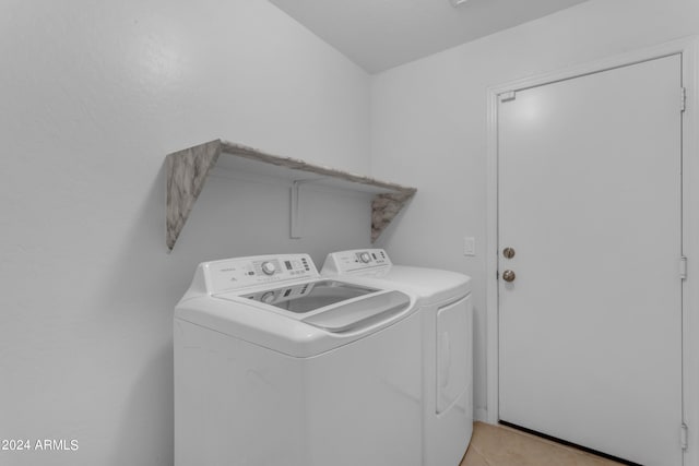 laundry area with light tile floors and washer and dryer