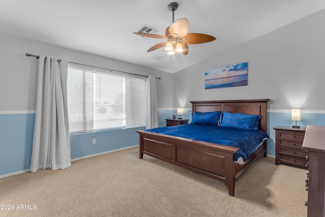 bedroom featuring lofted ceiling, ceiling fan, and light colored carpet