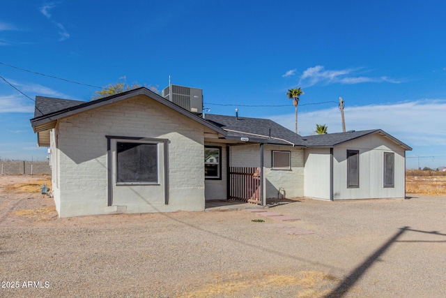 rear view of property with a patio and central air condition unit