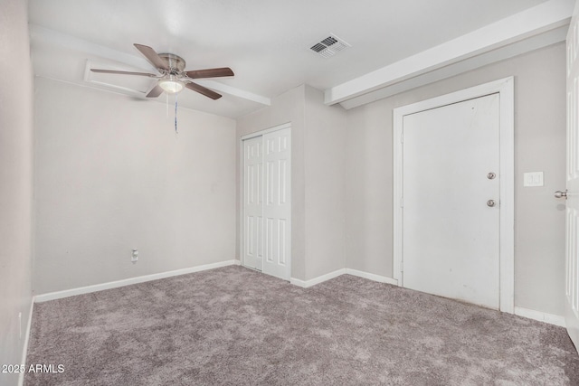 empty room with ceiling fan and carpet floors