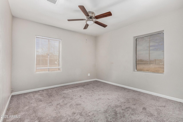 spare room featuring ceiling fan and carpet floors