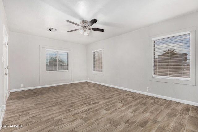 unfurnished room with ceiling fan and light wood-type flooring