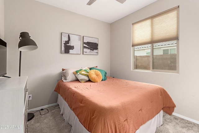 carpeted bedroom featuring baseboards and ceiling fan